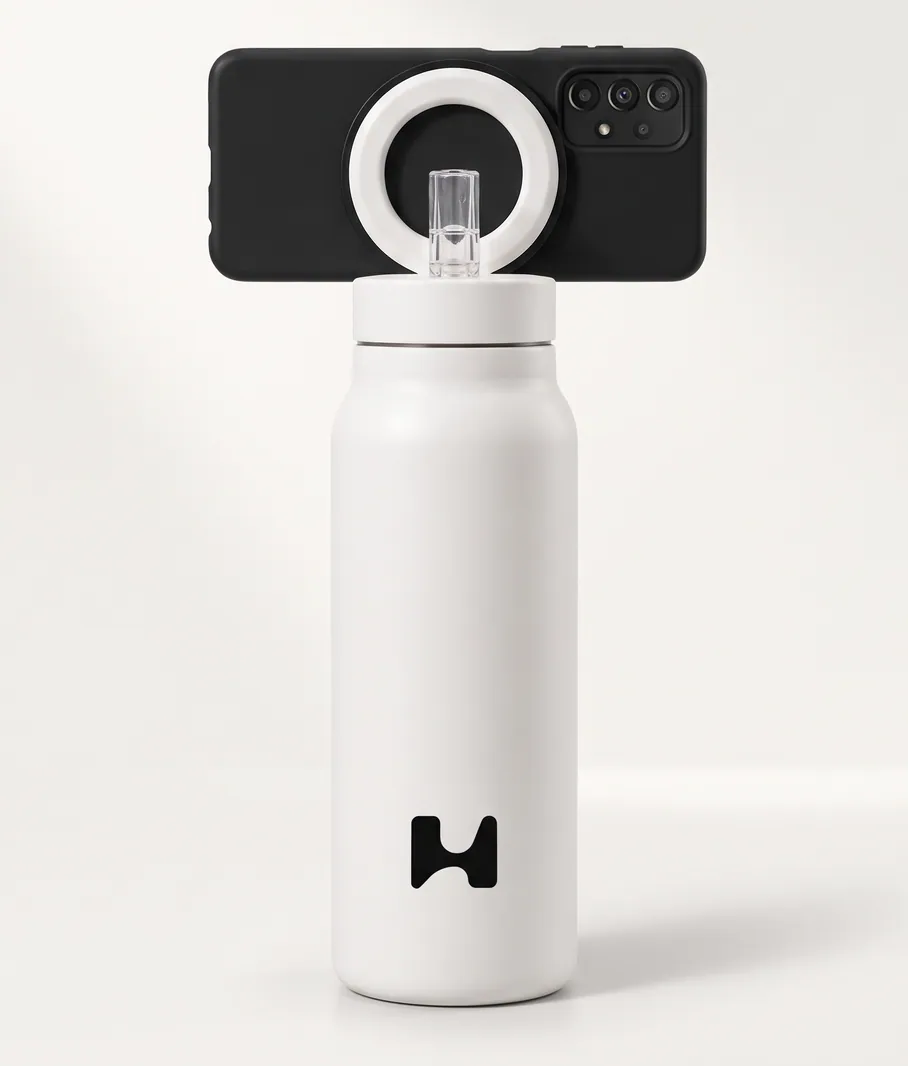 A phone in a black case held on the white bottle's ring by an adhesive magnetic adapter ring
